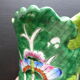 Ancient Asian ceramic vase green and white background decorated with butterflies