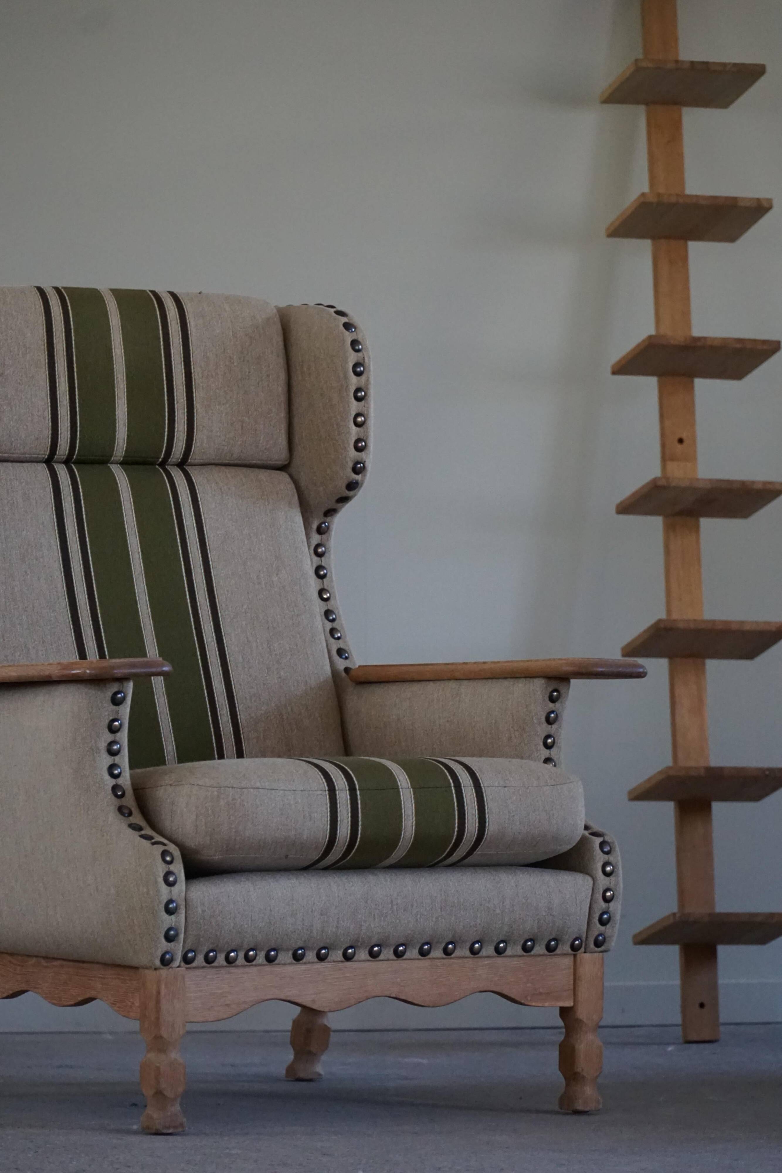 Pair of high-back lounge chairs in modern Danish style in the manner of Henning Kjærnulf, 1960s.