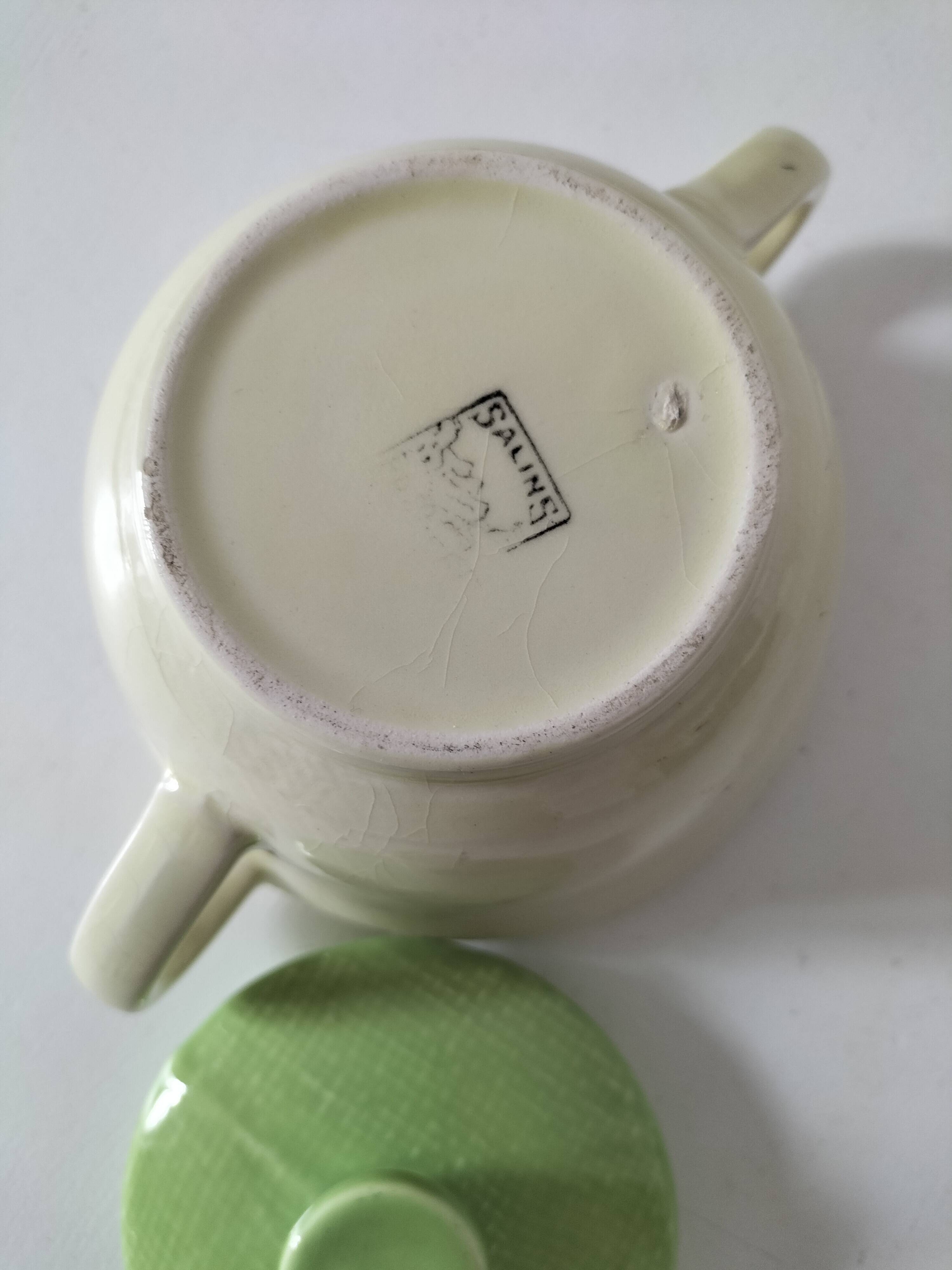 Two sugar bowls and a textured plate in turquoise and green Salins earthenware.