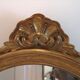 Miroir doré baroque ovale allongé