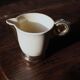 Ecru ceramic milk jug with gold decoration from Sarreguemines.
