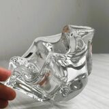 Empty pocket ashtray in transparent crystal organic shape.