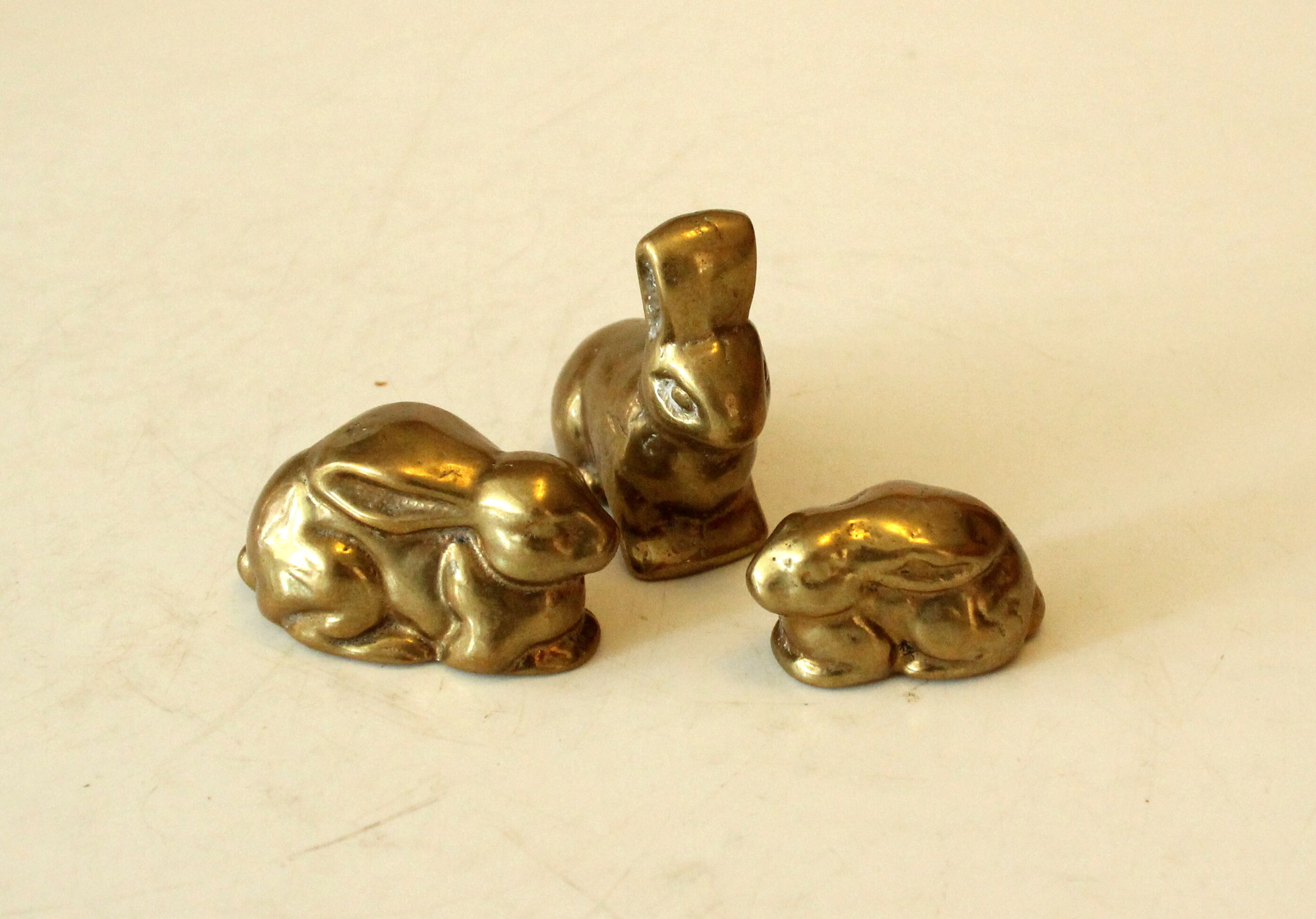 3 solid brass paperweights in the shape of rabbits vintage from the 1960s