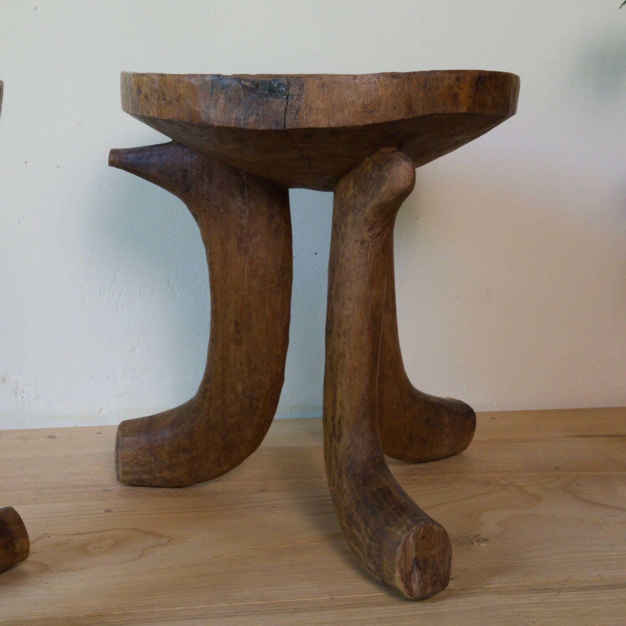 Pair of ancient Ethiopian tripod stools made of monoxyle wood.