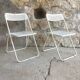 Pair of white perforated metal folding chairs - vintage