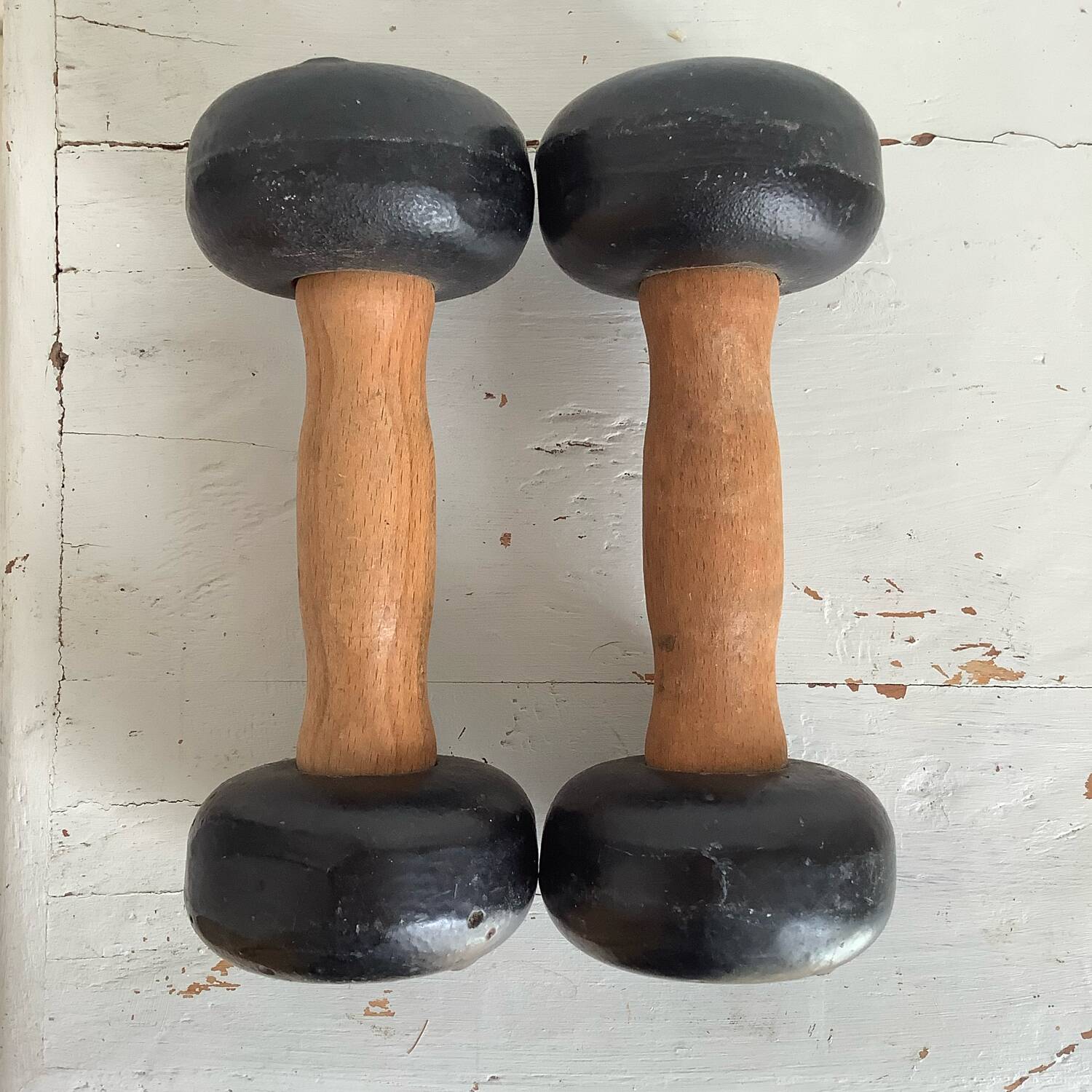 Pair of wooden and cast iron dumbbells