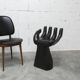 Black armchair chair in carved wood in the shape of a hand