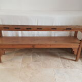 Church bench in fir tree with armrests