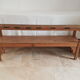 Church bench in fir tree with armrests