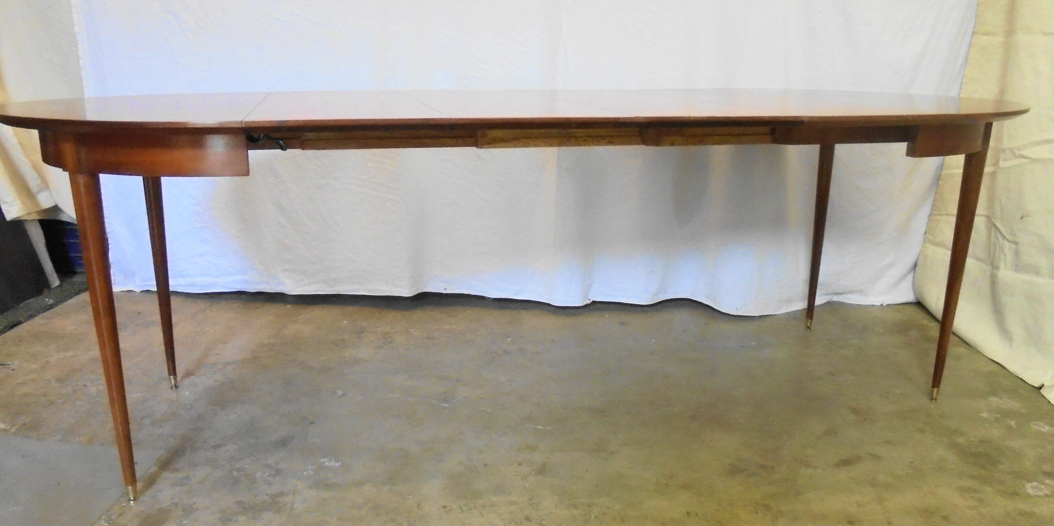 Mahogany round table with 4 extensions from the 1950s