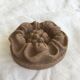 Pink sandstone paperweight in the shape of a rosette