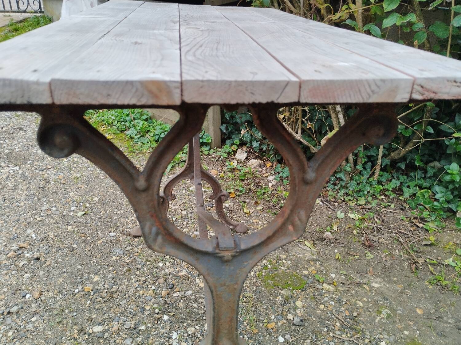Antique bistro table with iron legs and wooden top