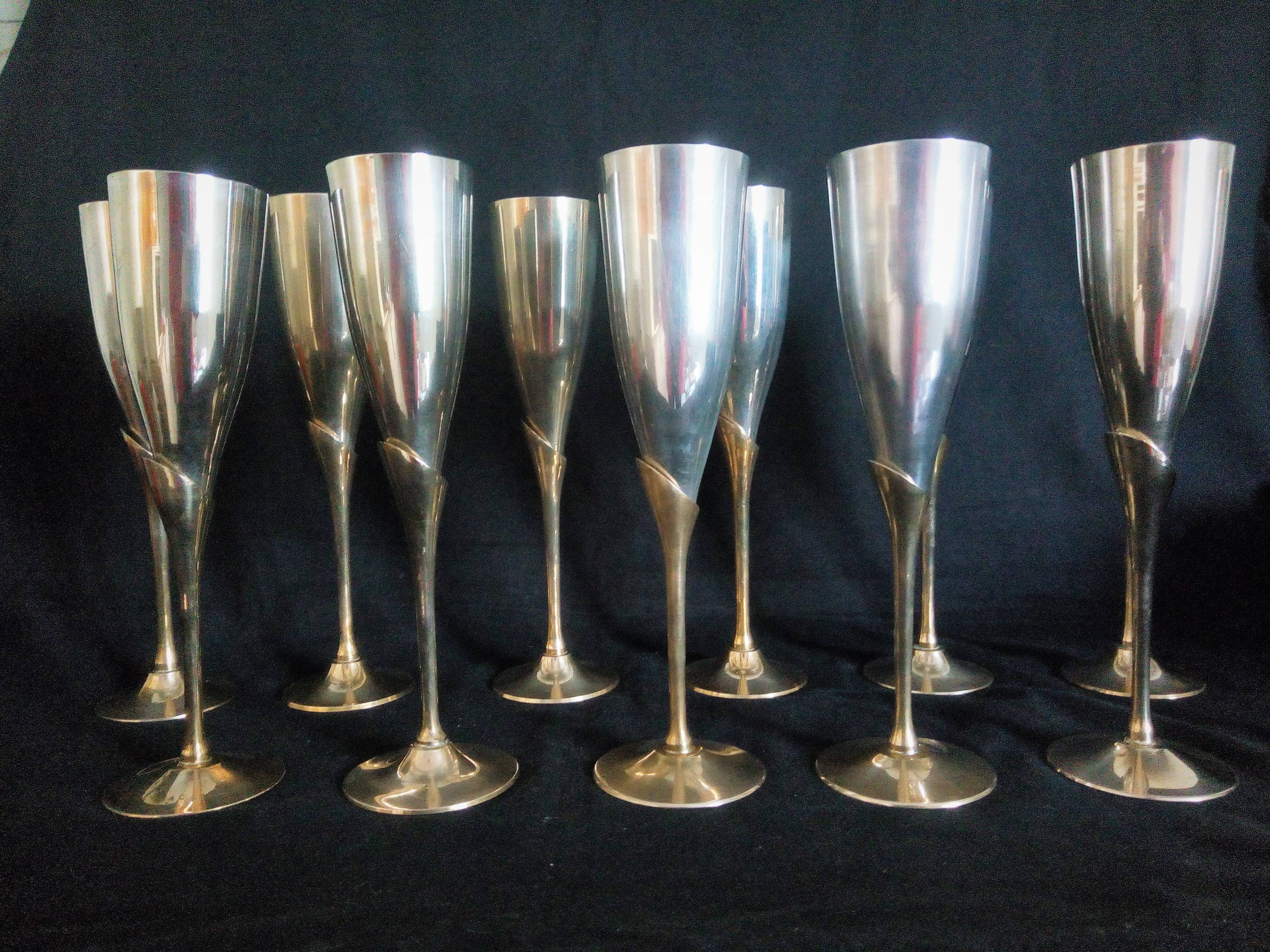 Lot of 12 silver metal flutes on brass stand