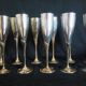 Lot of 12 silver metal flutes on brass stand