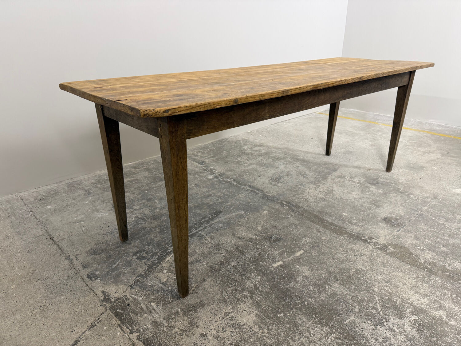 Old farmhouse table with tapered legs, late 19th to early 20th century.