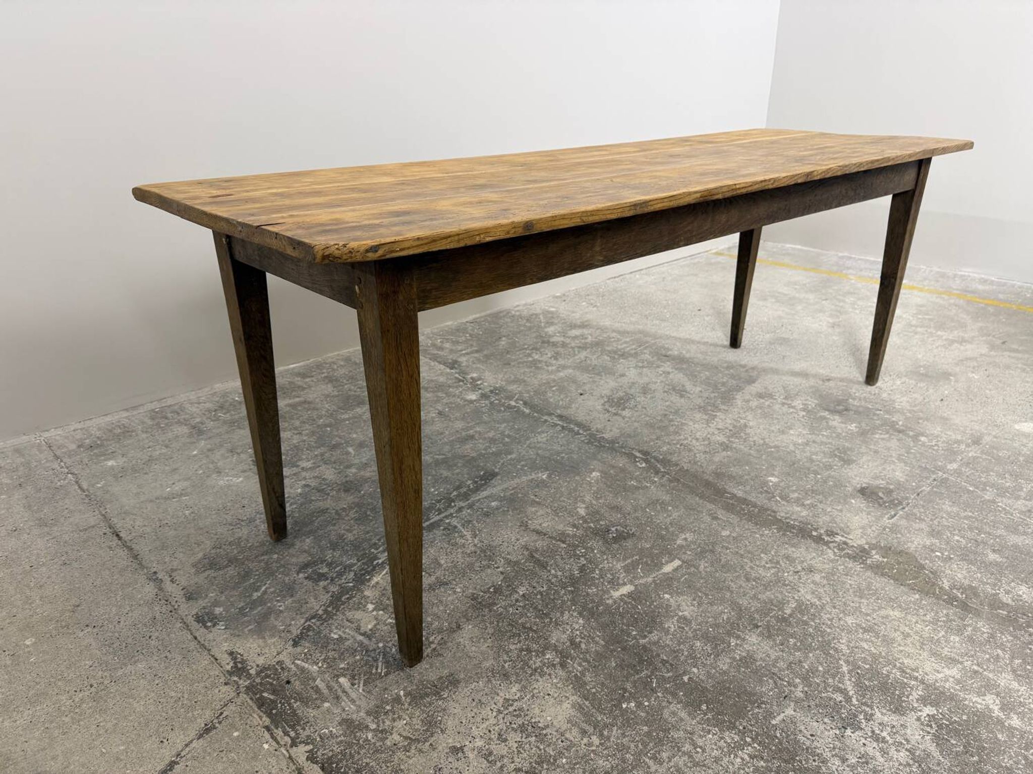 Old farmhouse table with tapered legs, late 19th to early 20th century.