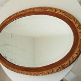 Antique oval mirror with beveled glass in wood and stucco, 19th century