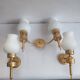 Three Empire style golden torch wall sconces