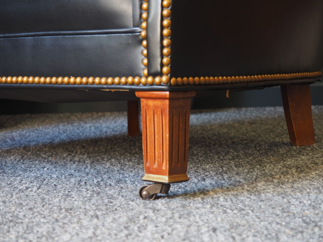 Chesterfield style leather armchair & footstool by Hancock & Moore