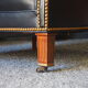 Chesterfield style leather armchair & footstool by Hancock & Moore