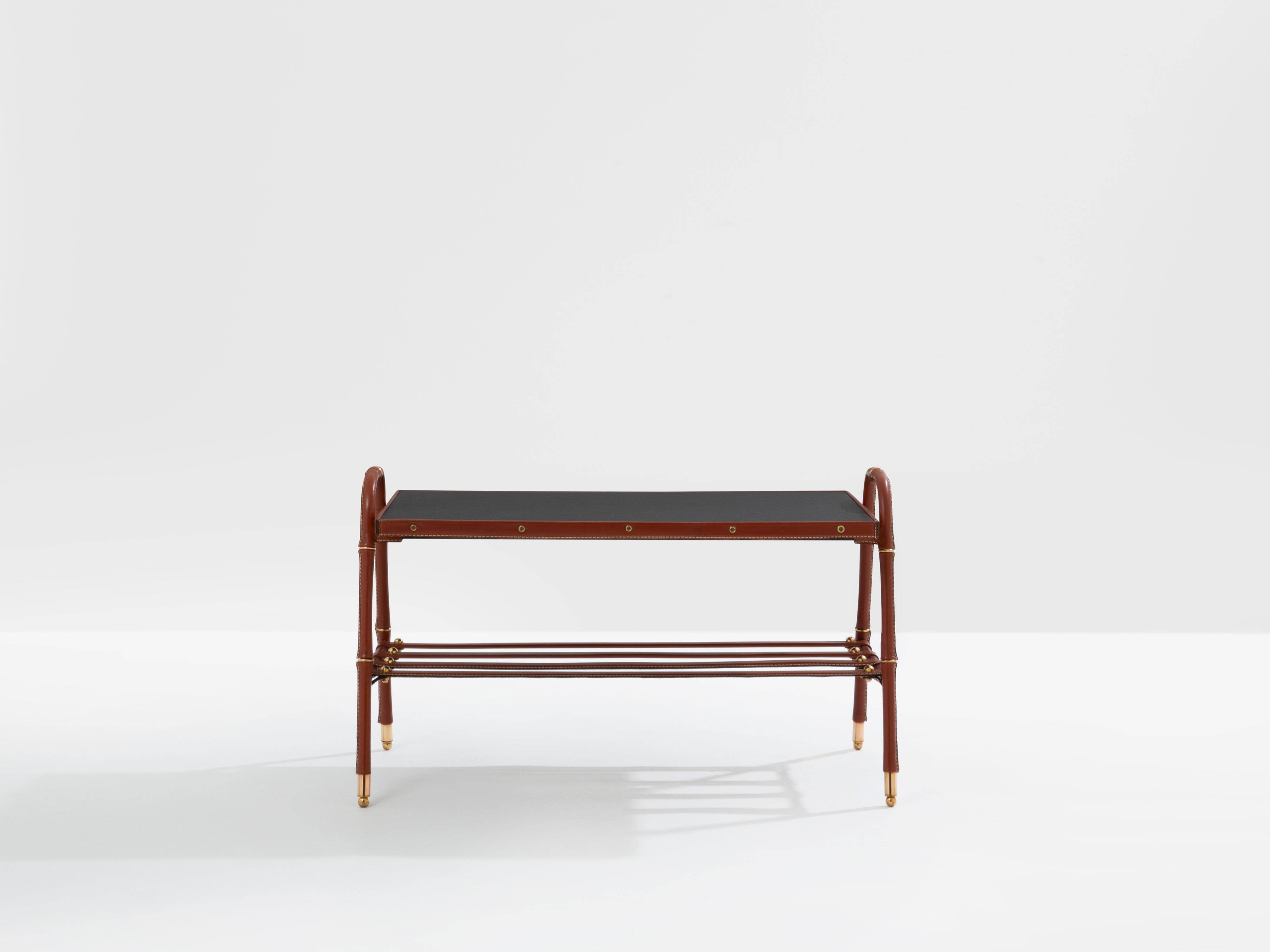 Jacques Adnet coffee table in red saddle-stitched leather and brass, 1950s