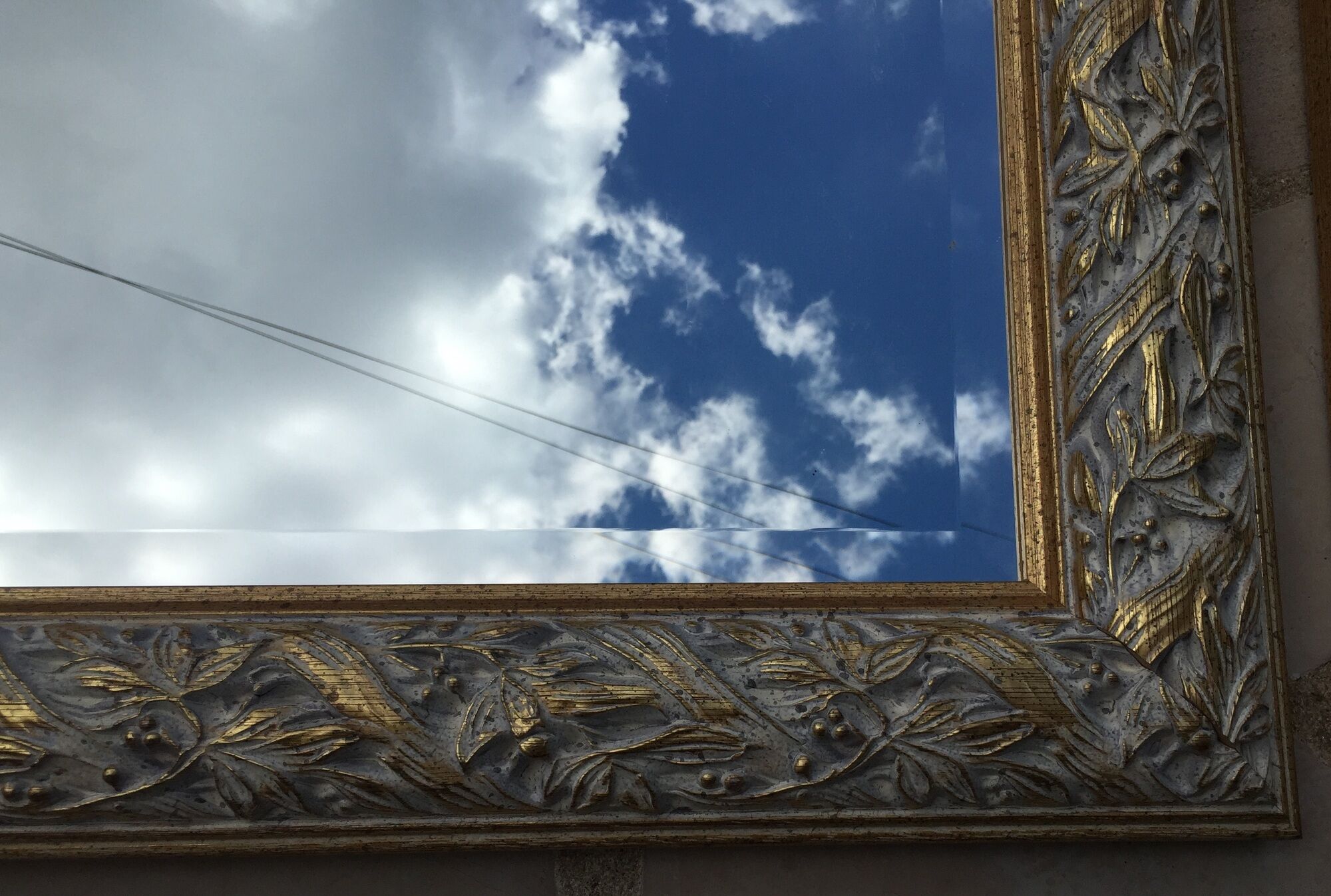 Pair of bevelled mirrors in white and gilded wood 86 x 66 cm