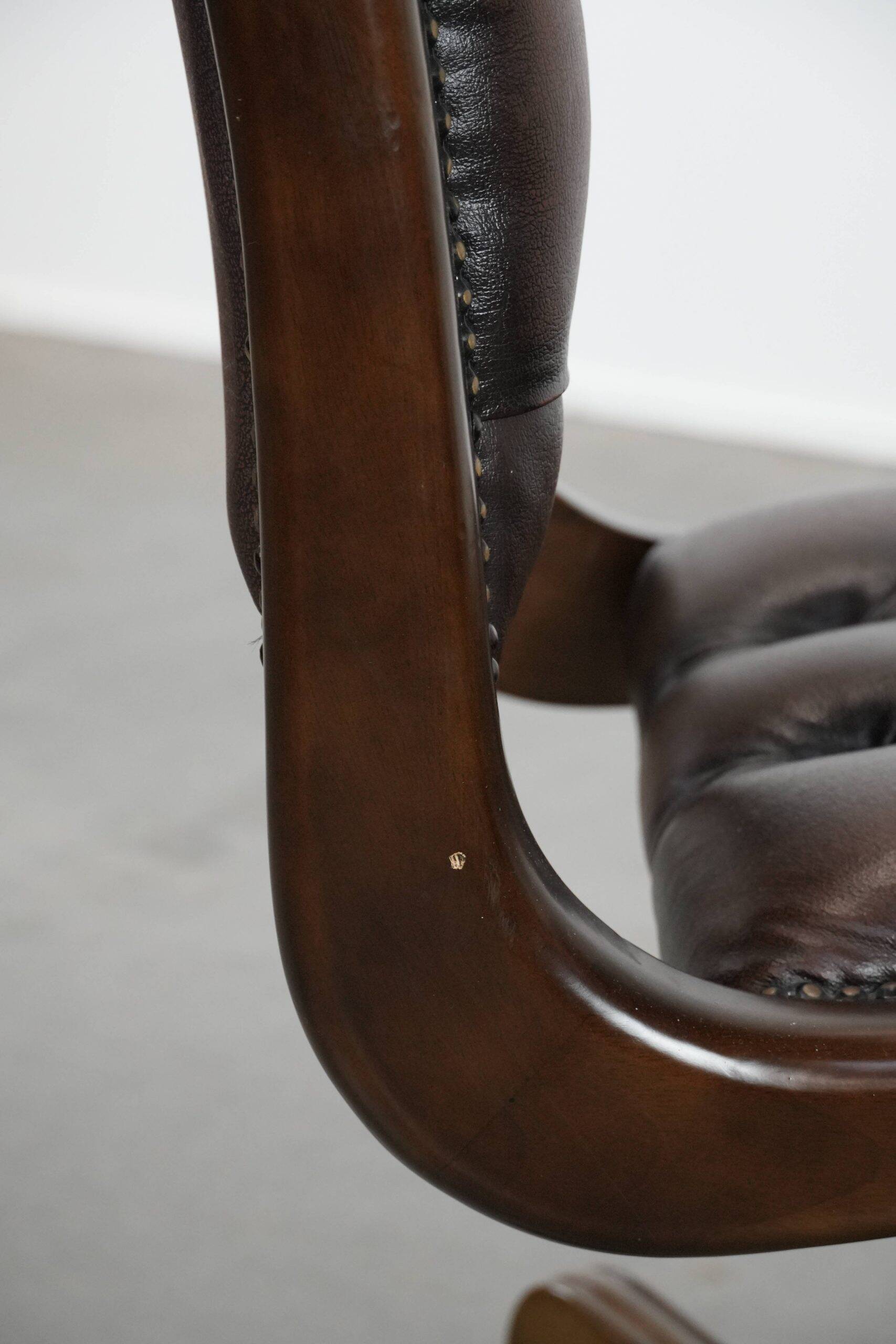 Chesterfield office chair in English style made of cow leather and wood.