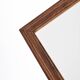 Old rectangular wooden mirror, frame decorated with edges