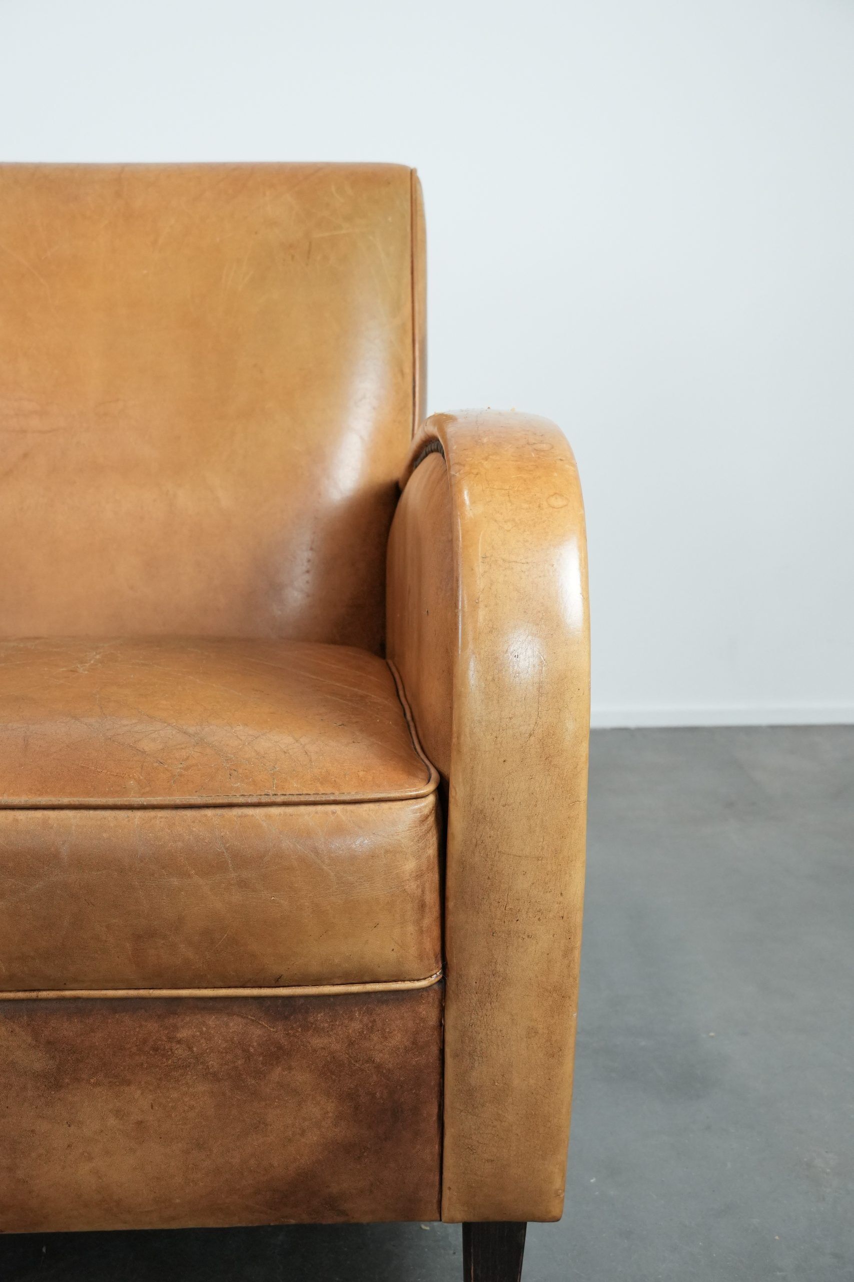 Luxury armchair made of cowhide leather with a beautiful warm colour scheme