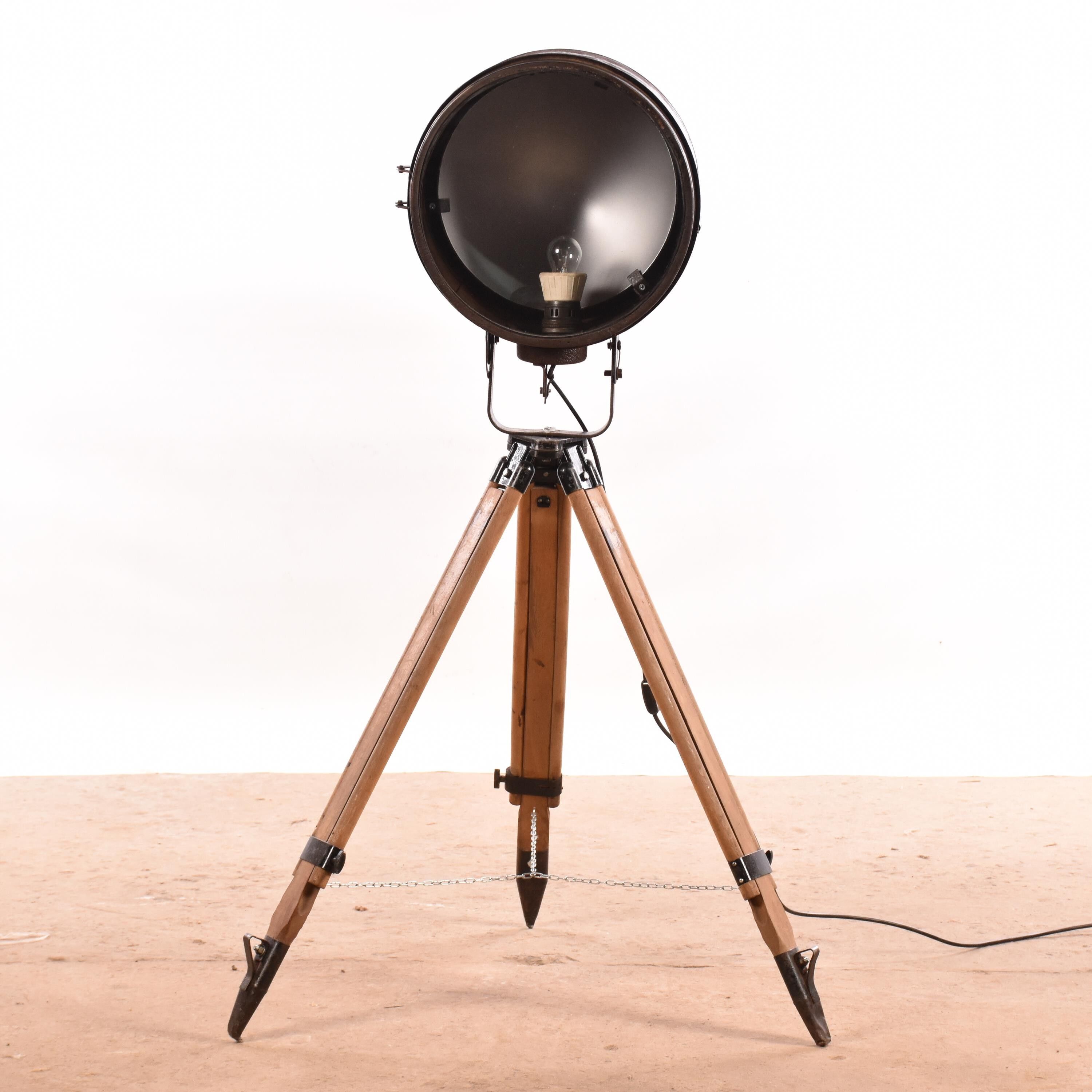 Old industrial spot on wooden tripod floor lamp