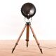 Old industrial spot on wooden tripod floor lamp