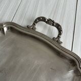 Silver metal serving tray with sculpted handles