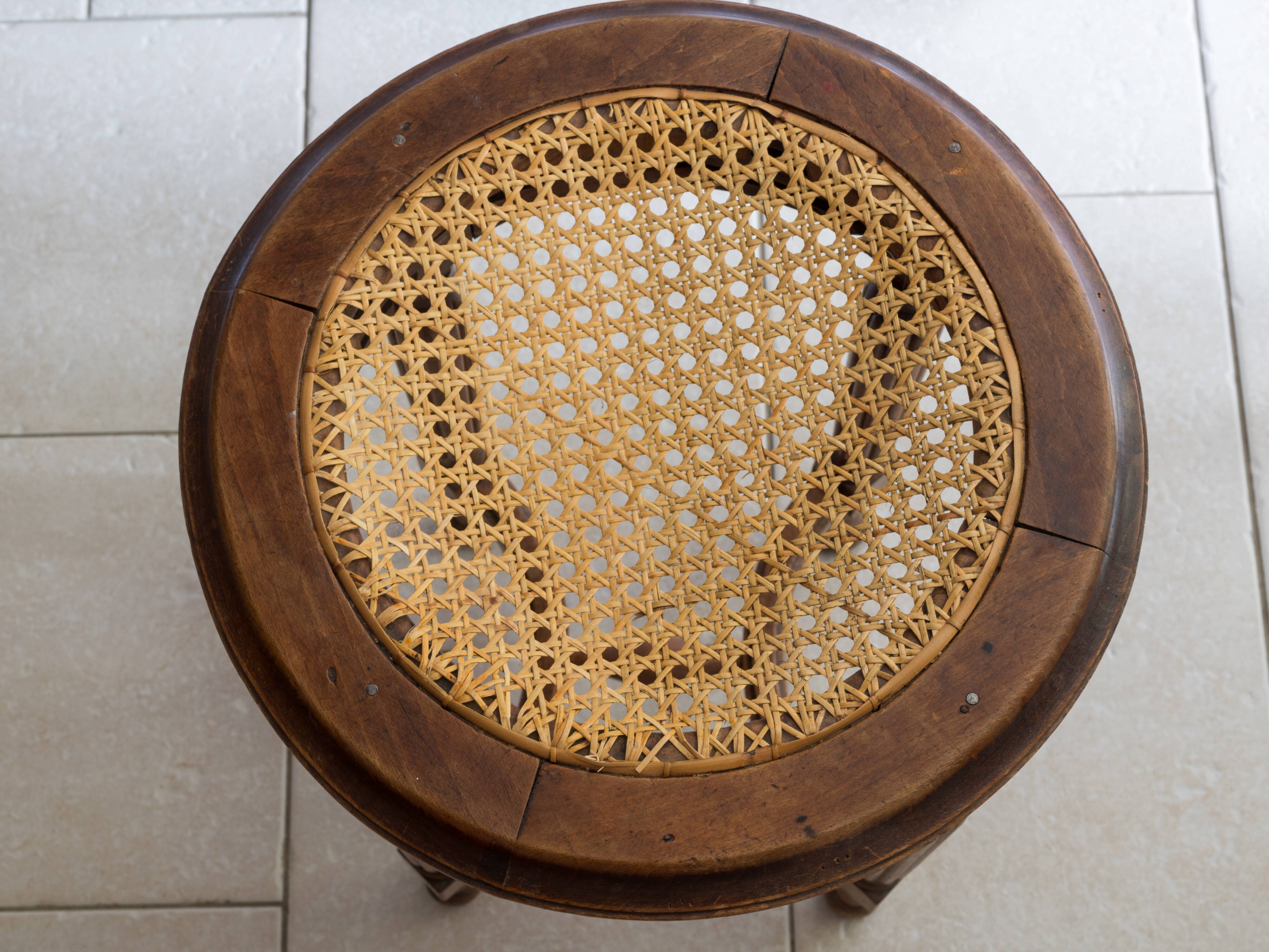 Antique armchair and stool with caned seat and fluted legs