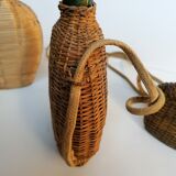 Trio of woven wicker bottles