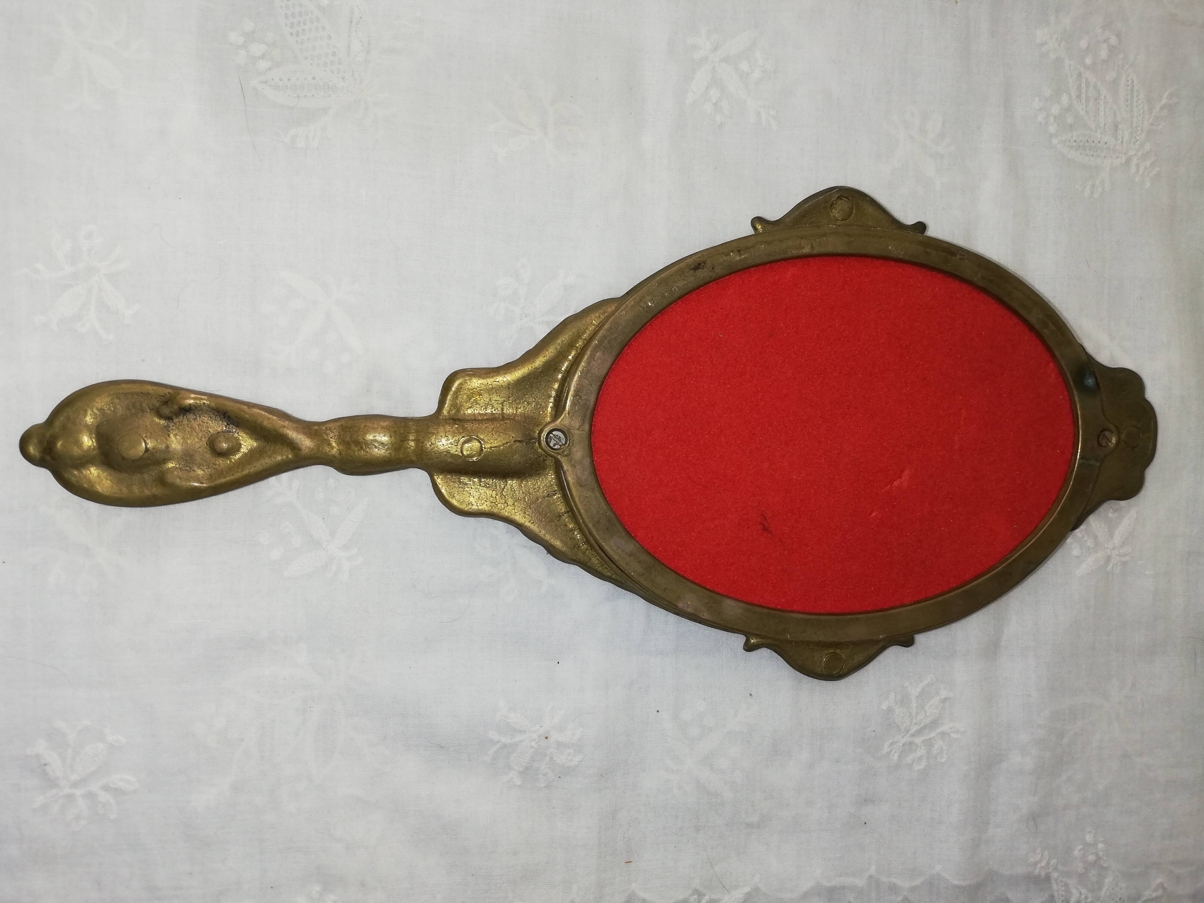 Old hand-facing mirror in gilded bronze