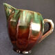 Large service in green and brown glazed stoneware with facets, signed Louis Cag.