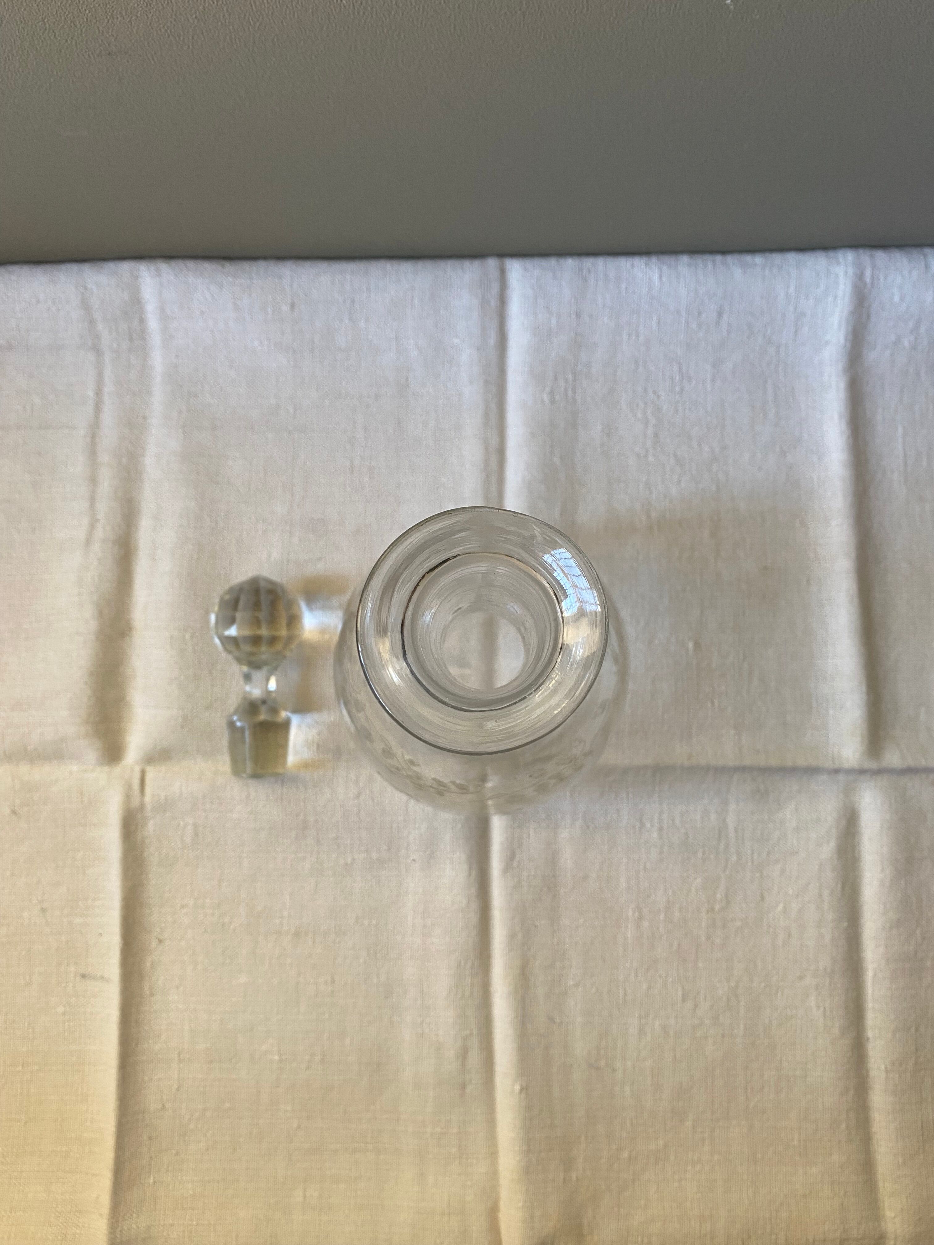 Carved glass decanter with floral decorations