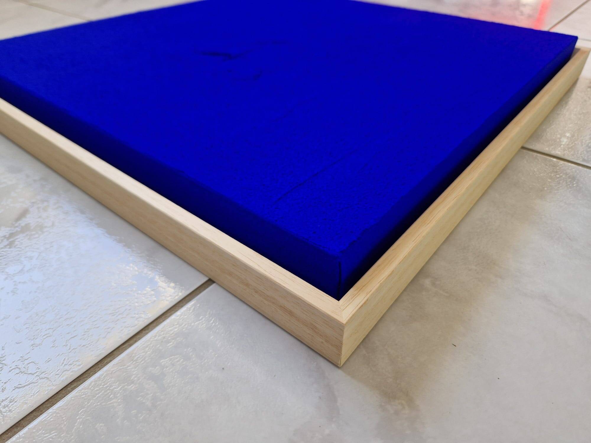 Framed monochrome blue abstract painting.