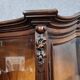 Curved library with two walnut doors, in Louis XV style.