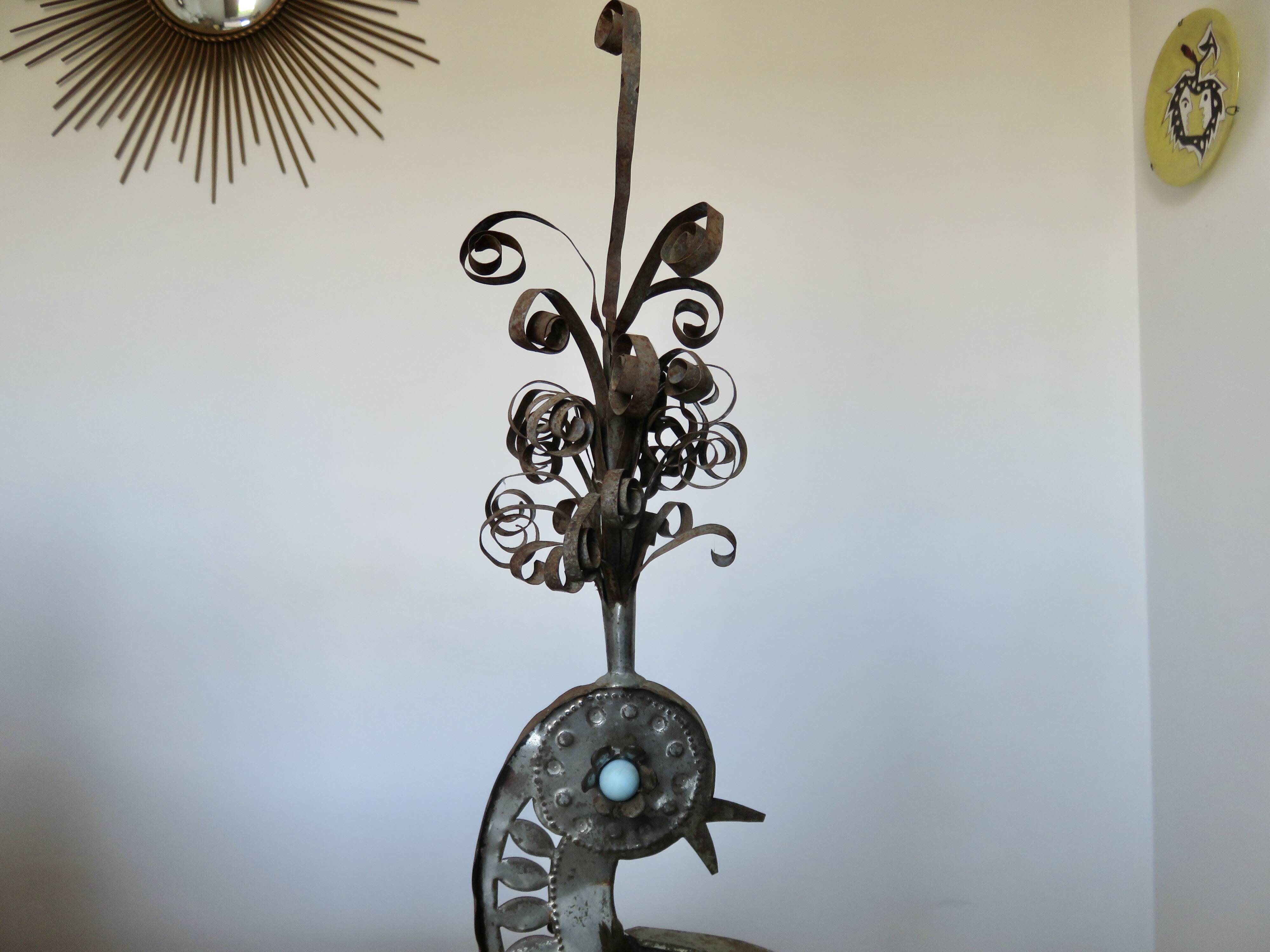 metal sculpture in sheet metal representing a peacock, work from the 1960s
