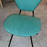 Chair in curved wood covered with vinyl, metal tube.