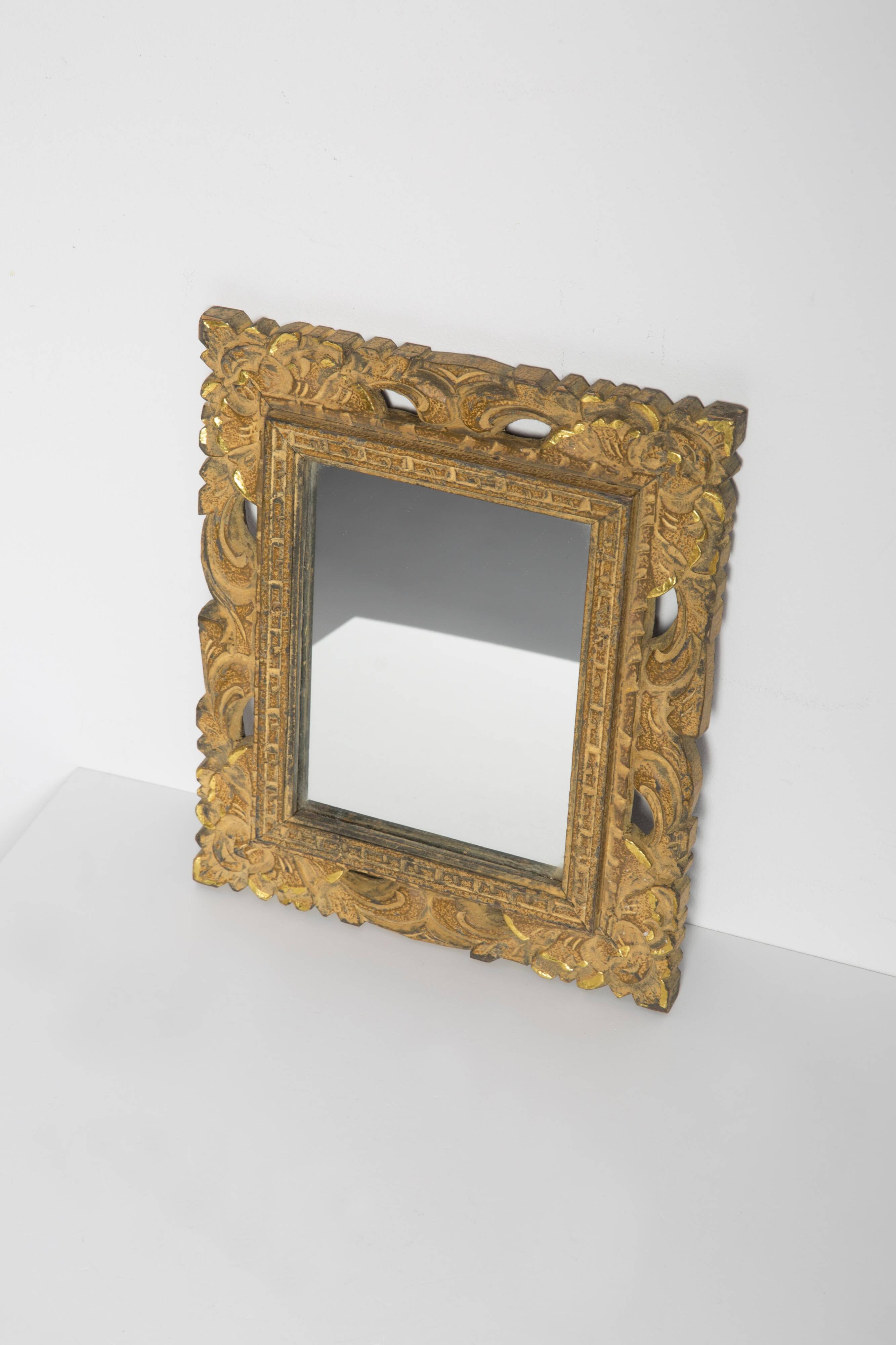 Decorative gold mirror mid-century in a wooden frame, Italy, 1960s.