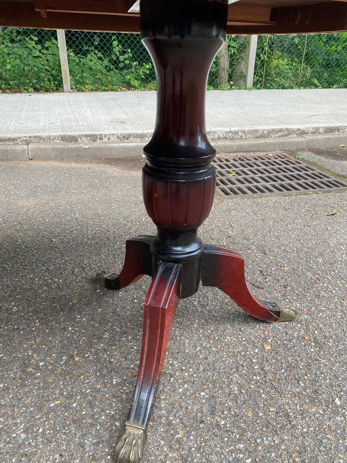 Glossy mahogany dining table in English Regency style from the 1970s.