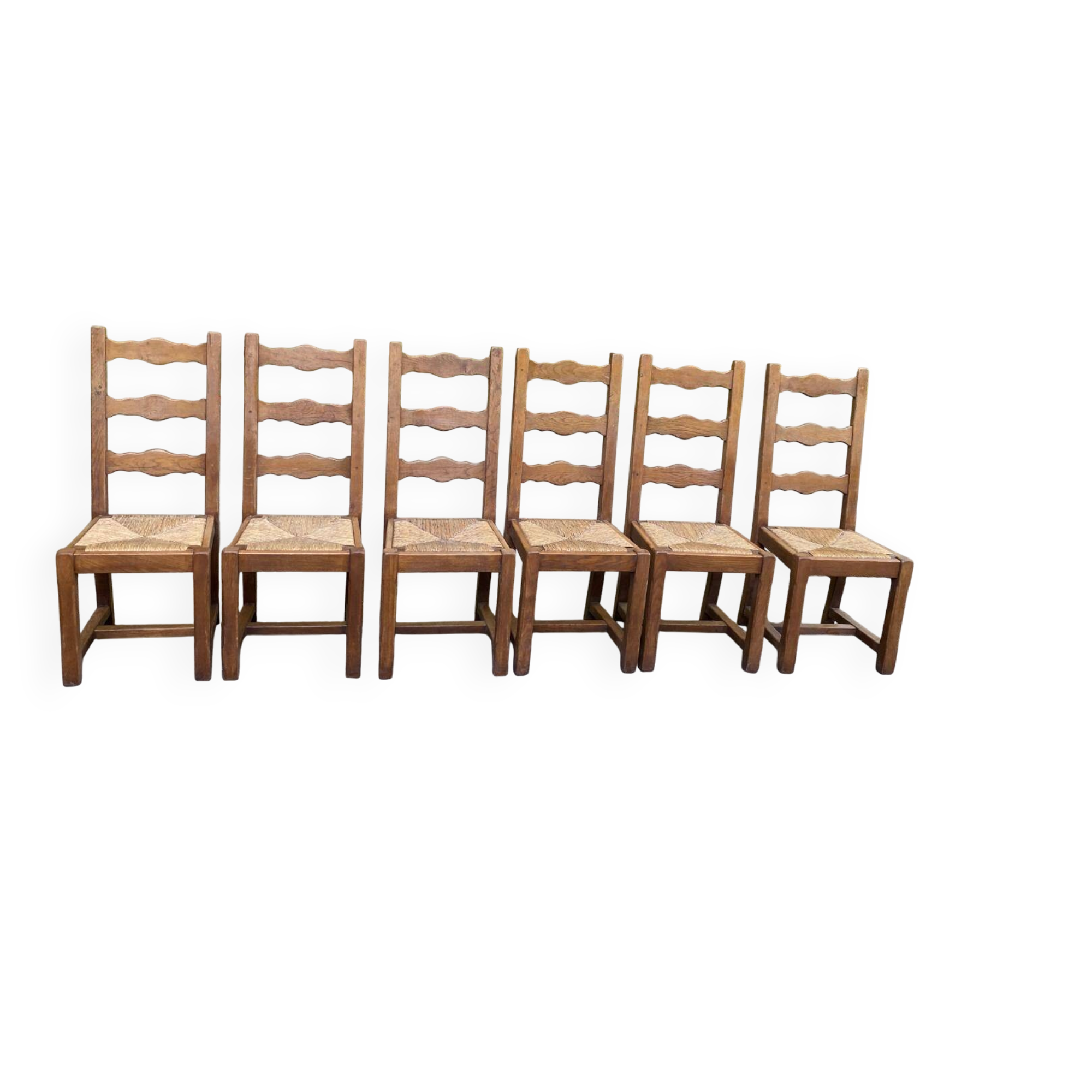 6 solid oak chairs with rush seats in a country style.