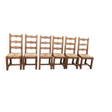 6 solid oak chairs with rush seats in a country style.