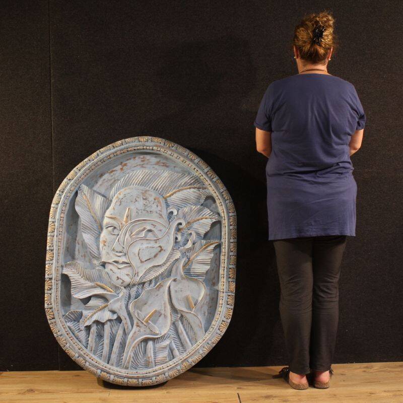 Bas-relief sculpture, stylized face with flowers, 20th century