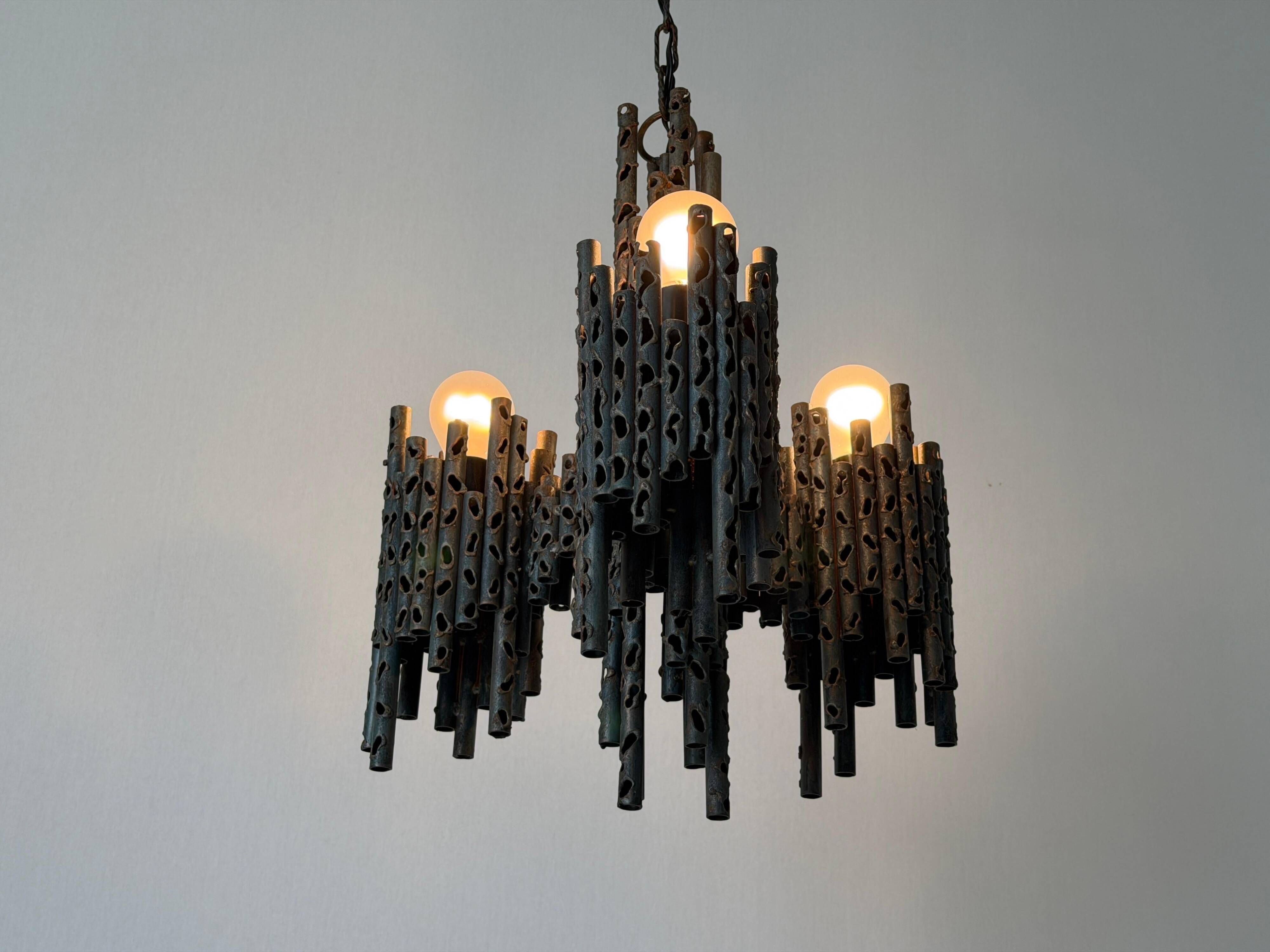 Three-armed suspended lamp in wrought iron, brutalist design, 1960s, Italy.