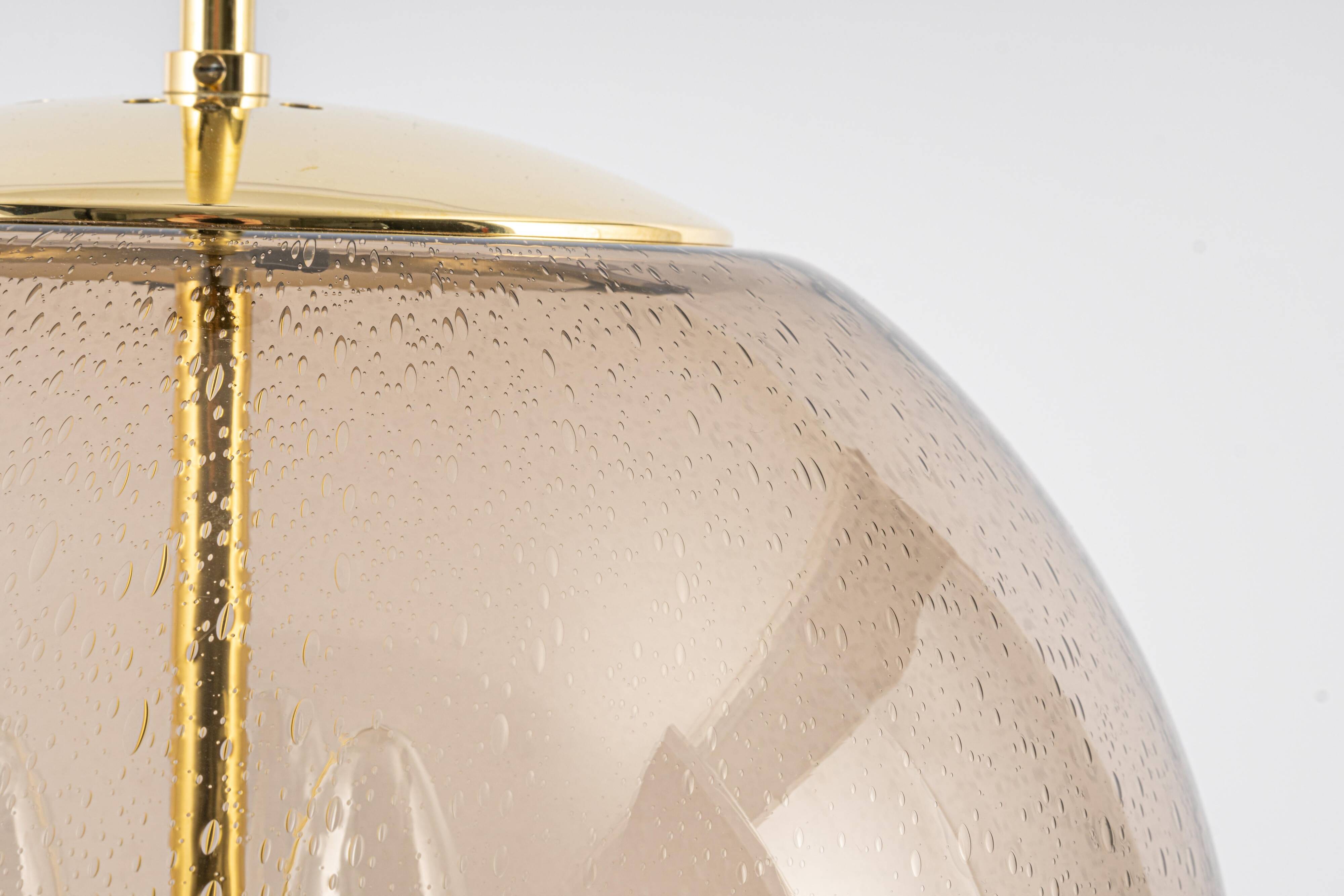 Large Limburg pendant light in brass with smoked glass ball, Germany, 1970s.