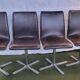 Set of 4 metal and imitation leather swivel chairs.