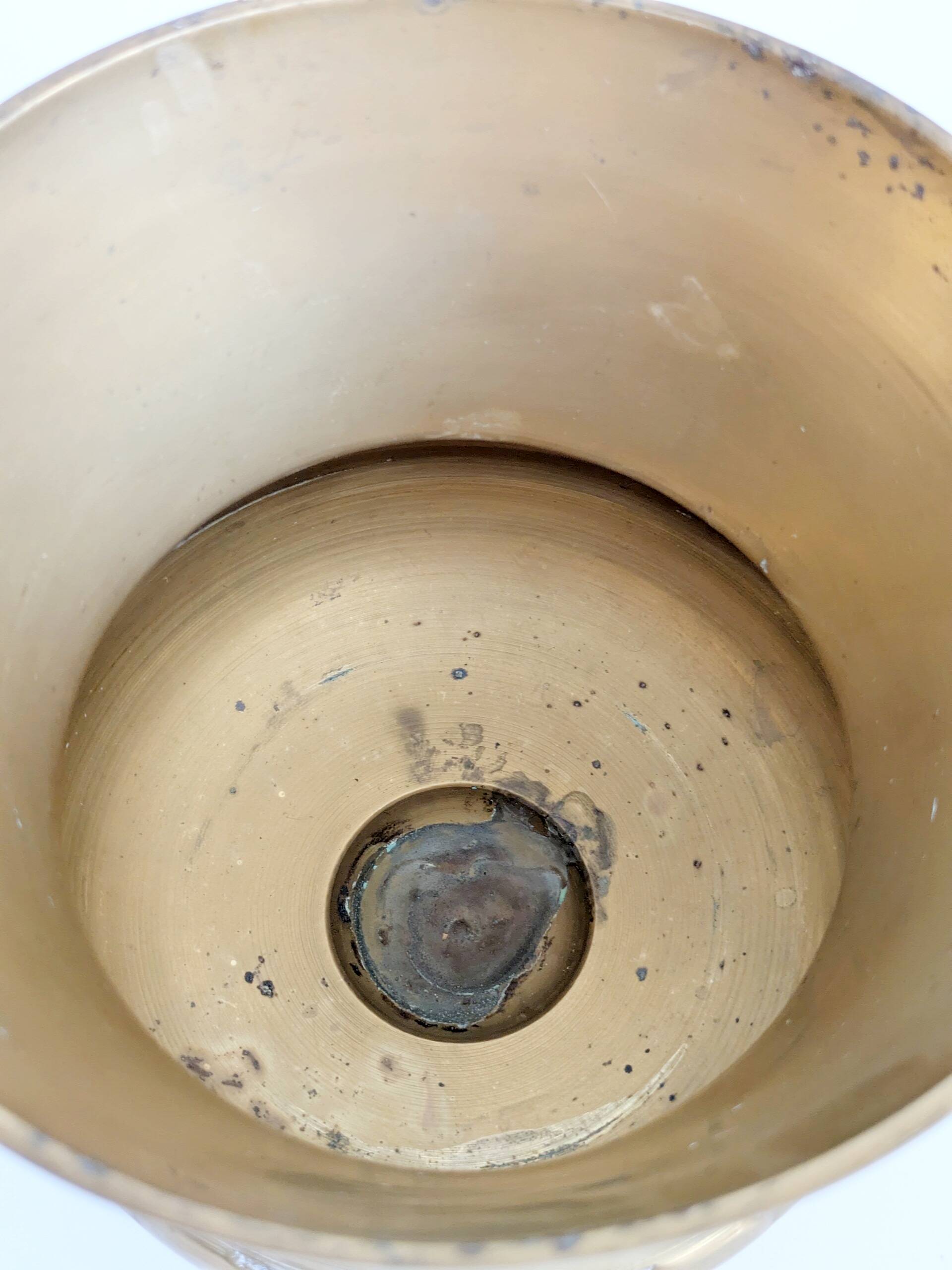 Vintage brass cache-pot on a stand with handles, classic decor.